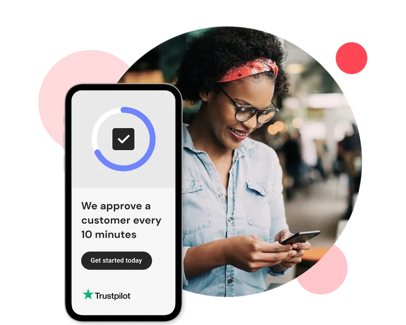Smiling woman wearing glasses and a headband checks her phone, with an overlay graphic showing a mobile app screen stating "We approve a customer every 10 minutes" alongside a Trustpilot rating